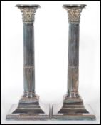 A pair of early 20th Century Edwardian silver plate Corinthian column candlesticks, each with