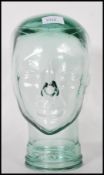 A vintage 20th Century point of sale advertising Milliners display pressed glass phrenology head.