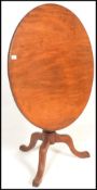 A 19th Century mahogany tilt top tripod wine table, with circular top raised on a turned baluster