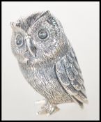 A sterling silver novelty figurine of an owl. Stamped to the base Sterling. Weighs 18g. Measures 4cm