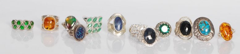 A group of twelve silver rings of various designs, multiple coloured stone examples, two set with