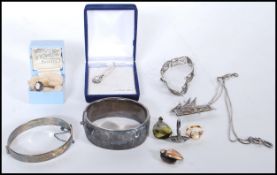 A collection of silver to include hallmarked ladies large chase decorated bangle , silver hallmarked