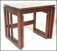 A 1970's retro vintage mahogany graduating nest of tables in the quadrille pattern. The tables
