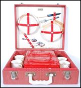 A mid century retro, circa 1950's Brexton style picnic hamper set within its original red vinyl