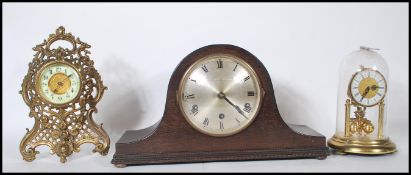 An early 20th century gilt metal mantel clock with rococo design together with a 1920's Napoleons