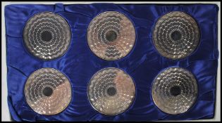 A silver hallmarked set of boxed coasters with engine turned decoration. Hallmarked for