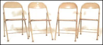 A set of 4 mid 20th century  tubular metal industrial folding / stacking chairs. Each with painted
