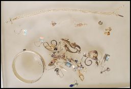 A collection of silver and gold jewellery to include a silver 925 bangle with safety chain, pair