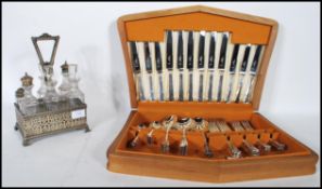 A 19th Century silver plate and cut glass cruet set, the fret pierced gallery surround having an