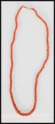 An early 20th century salmon / red natural coral necklace being set with a 9ct rose gold clasp.