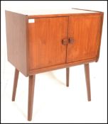 A retro 20th Century teak wood twin door recorded cabinet / cupboard having square handles with