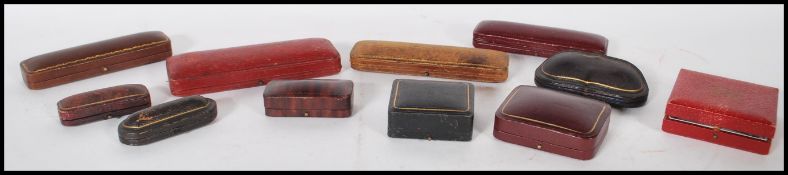 A group of eleven early to mid 20th Century coloured leatherette jewellery boxes of different