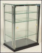 A 20th Century retro glass point of sale counter top display cabinet, sliding doors to the back with