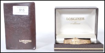 A vintage 9ct gold 1970's Longines ladies cocktail watch having a square face with a champagne