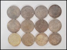 A collection of 12 20th Century Chinese coins marked kwang-tung province 7 mace and 2 candareens