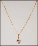 A stamped 916 22ct gold pendant necklace having a fine link chain having a pendant set with two