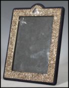 A continental silver easel back picture / photo frame having embossed Rococo influence scrolls and