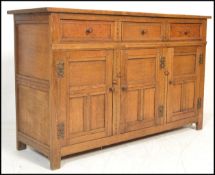 A 20th Century oak Jacobean revival sideboard credenza, flared top over a configuration of drawers