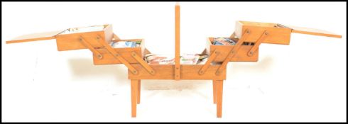A retro 20th Century teak wood concertina metamorphic action work box / sewing box, the multi