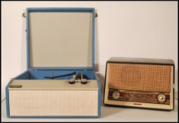A retro mid century Tellux portable record player in a blue and white colourway together with a
