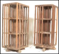 An unusual pair of 20th century hardwood Industrial style large revolving bookcases. Each on splayed
