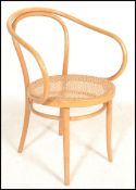 A vintage retro 20th century bentwood elbow bistro armchair in the manner of Thonet, the bentwood