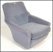A vintage 20th Century Danish inspired arm lounge chair having blue upholstery with button back