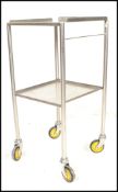 A vintage 20th Century chrome medical trolley having two tiers raised on round tubular supports with