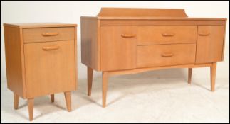 A retro 20th Century light teak wood sideboard having a back rail with a bank of two drawers to