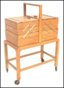 A vintage retro 20th Century cantilever multi seconal elm work box / sewing box on stand, carry