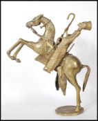 An early 20th Century African Benin style cast brass figurine of a rearing horse with a rider