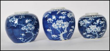 A group of three Chinese blue and white ginger jars to include two larger jars and one smaller,