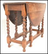 A 1920's early 20th Century good quality light oak drop leaf dining table being raised on barley