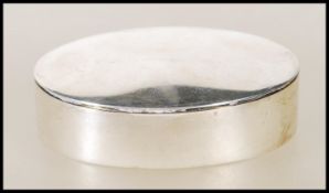 A silver hallmarked ladies pill box of oval / lozenge form complete with the lid. Birmingham