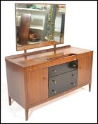 A mid century teak wood dressing table with ebonised central chest of drawers and a dressing
