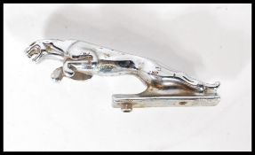 A vintage Jaguar car mascot modelled as a Jaguar leaping, the base having two threaded fixing holes.