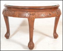 A 20th Century Chinese carved hardwood round tea table with quartetto nesting stools. The deep