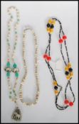 A group of 1930's Art Deco necklaces to include a long beaded bakelite flapper necklace having round