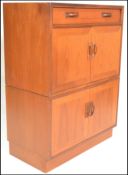 A retro 20th Century G Plan teak wood tallboy unit having a single drawer above two twin door