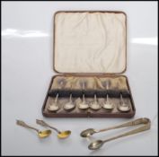 A cased set of six early 20th Century Art Deco silver hallmarked coffee spoons of simple form.