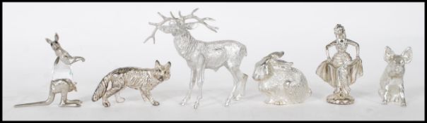 A collection of white metal figurative animals to include a kangaroo with crystal glass body,