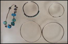 A selection of silver bracelets to include a bangle set with oval turquoise cabochons, a Rhona