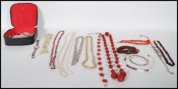 A collection of vintage 20th Century costume jewellery to include baroque pearls, Cloisonne bangles,