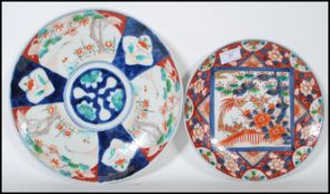 A 19th Century Chinese charger decorated with a central circular panel surrounded by six panels