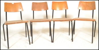 A set of 4 mid 20th century bentwood and tubular metal industrial stacking chairs. Each with painted