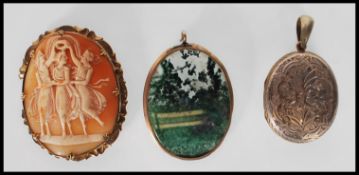 A 9ct gold Victorian cameo brooch depicting the three graces together with a 9ct gold window