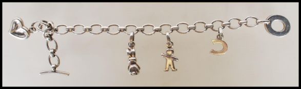 A sterling silver charm bracelet by Links of London having four charms each one bearing hallmarks.
