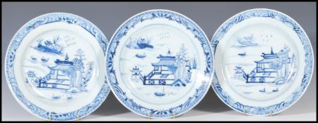 A group of three Chinese 18th Century ceramic blue and white plates all hand painted with a pagoda