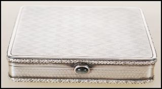 An early 20th Century continental silver cigarette case of square form having relief floral