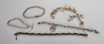 A group of five silver bracelets to include a silver charm bracelet consisting of london bus, plane,